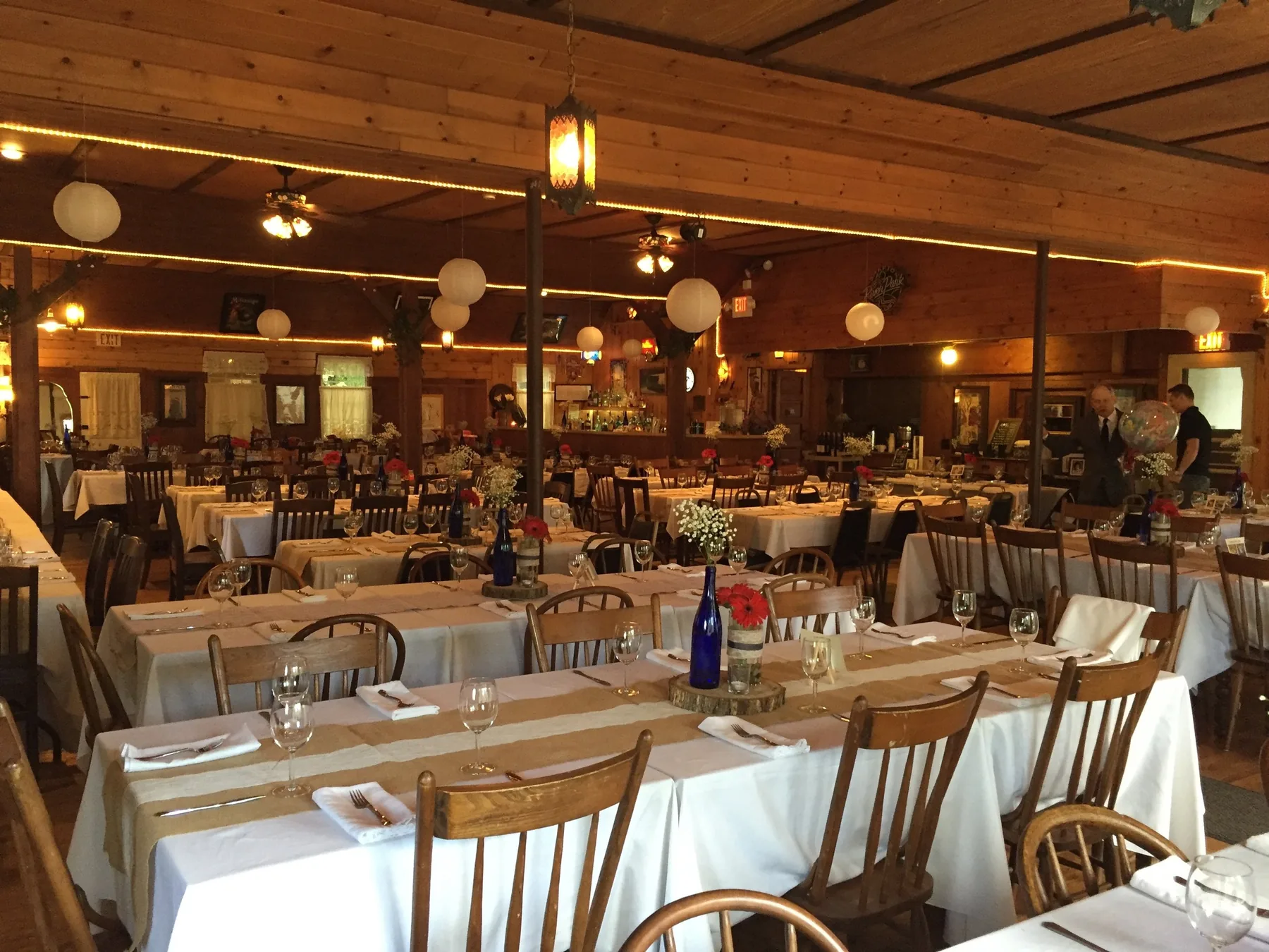 Reception hall arranged with tables and warm lighting